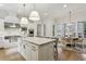 Elegant kitchen features stone countertops, large island with seating, and stainless steel appliances at 2671 Bohler Nw Rd, Atlanta, GA 30327