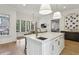 Gourmet kitchen with a large center island, breakfast bar, and adjacent breakfast nook with backyard views at 2671 Bohler Nw Rd, Atlanta, GA 30327