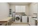 Well-equipped laundry room with a washer, dryer, sink, and ample storage space for convenience at 2671 Bohler Nw Rd, Atlanta, GA 30327