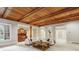 This living room offers a bar, wood accents, coffered ceilings, and bright white sofa, perfect for entertaining at 2671 Bohler Nw Rd, Atlanta, GA 30327