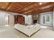 Inviting living room features a stone fireplace, wood paneled ceiling, built in shelving, and comfortable white sofa at 2671 Bohler Nw Rd, Atlanta, GA 30327