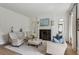 Elegant living room with a fireplace, neutral furniture, and natural light at 2671 Bohler Nw Rd, Atlanta, GA 30327