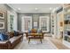 Bright living room with two leather sofas, a neutral rug, and natural light from the windows at 2671 Bohler Nw Rd, Atlanta, GA 30327
