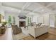 Spacious living room with hardwood floors, fireplace, coffered ceiling, and backyard views at 2671 Bohler Nw Rd, Atlanta, GA 30327