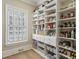 Well-organized pantry with floor-to-ceiling shelving and ample storage space by a window at 2671 Bohler Nw Rd, Atlanta, GA 30327