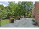Spacious stone patio with iron railing, potted plants, and outdoor seating area for entertaining at 2671 Bohler Nw Rd, Atlanta, GA 30327
