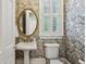 Charming powder room with floral wallpaper, a pedestal sink, and elegant mirror at 2671 Bohler Nw Rd, Atlanta, GA 30327