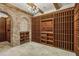 Stunning wine cellar with brick archway, stone flooring, and custom wood racking for an extensive collection at 2671 Bohler Nw Rd, Atlanta, GA 30327