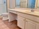 Bathroom vanity and countertop featuring a built-in drawer and a sink with gold fixtures at 302 Gladstone Dr, Mcdonough, GA 30253