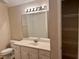 Bathroom featuring a vanity with storage, a large mirror, and modern lighting fixtures at 302 Gladstone Dr, Mcdonough, GA 30253