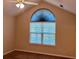 Bedroom with carpet flooring, a ceiling fan, and a large window providing natural light at 302 Gladstone Dr, Mcdonough, GA 30253