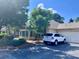 View of the home's exterior featuring a two-car garage and a neatly parked vehicle at 302 Gladstone Dr, Mcdonough, GA 30253