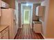 Long hallway between the kitchen and other parts of the house with plank flooring at 302 Gladstone Dr, Mcdonough, GA 30253