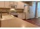 Bright kitchen with countertops and white appliances, including a microwave and refrigerator at 302 Gladstone Dr, Mcdonough, GA 30253