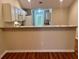 Well-lit kitchen with a breakfast bar, white cabinets, and modern appliances at 302 Gladstone Dr, Mcdonough, GA 30253