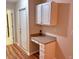 A home office nook featuring white cabinets and drawers for storage, next to an exterior door at 302 Gladstone Dr, Mcdonough, GA 30253