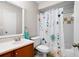 Bathroom with vanity sink, toilet, and shower with floral curtain at 3160 Seven Pines Unit 105 Ct, Atlanta, GA 30339