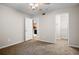 Bedroom with carpet, ceiling fan, and access to a closet and an open doorway at 3160 Seven Pines Unit 105 Ct, Atlanta, GA 30339