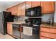 Kitchen featuring granite counter tops and black appliances, including an oven and dishwasher at 3160 Seven Pines Unit 105 Ct, Atlanta, GA 30339
