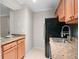 Kitchen featuring a stainless steel sink, granite countertops, and wooden cabinets at 3160 Seven Pines Unit 105 Ct, Atlanta, GA 30339