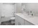 A well-lit bathroom with a sleek vanity, a white sink, and a shower-tub combination at 402 Retreat Ln, Canton, GA 30114