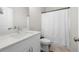 Clean bathroom featuring a white vanity, toilet, and shower with a curtain at 402 Retreat Ln, Canton, GA 30114