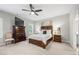 Spacious bedroom with a large bed, dark wood furniture, and neutral walls at 402 Retreat Ln, Canton, GA 30114
