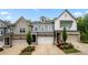Attractive townhomes with varied facades, manicured landscaping, and individual driveways and garages at 402 Retreat Ln, Canton, GA 30114