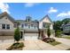 Townhome with a three car garage, well manicured front yard, and colorful flowers at 402 Retreat Ln, Canton, GA 30114