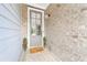 Charming front entrance with a light gray door, brick facade, and 'Thankful' welcome mat at 402 Retreat Ln, Canton, GA 30114