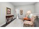Hallway area with hardwood floors, accent table, chair, and framed art at 402 Retreat Ln, Canton, GA 30114