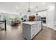 Open floor plan featuring a kitchen island that flows into the living room and dining area at 402 Retreat Ln, Canton, GA 30114