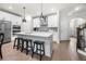 Modern white kitchen features a large island, stainless steel appliances, and sleek pendant lighting at 402 Retreat Ln, Canton, GA 30114