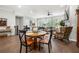 Bright open-plan living and dining area featuring hardwood floors and large windows at 402 Retreat Ln, Canton, GA 30114