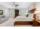 Bedroom showcasing ample natural light, neutral walls, with a large bed and comfortable seating area at 402 Retreat Ln, Canton, GA 30114