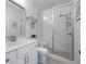Modern bathroom features a tiled shower with glass doors, white vanity, and a stylish mirror at 414 Concord St, Alpharetta, GA 30009