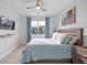 Cozy bedroom features a bed with a decorative headboard, TV, and a bright window with blue curtains at 414 Concord St, Alpharetta, GA 30009