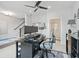 Well-lit bedroom featuring a desk, ceiling fan, and adjacent bathroom at 414 Concord St, Alpharetta, GA 30009