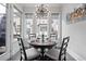 Cozy dining area with modern light fixture, table set for four, and view of the backyard at 414 Concord St, Alpharetta, GA 30009