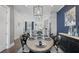 Open-concept dining area with modern decor, an elegant table setting, and seamless flow to the kitchen at 414 Concord St, Alpharetta, GA 30009