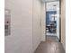 Hallway features a residential elevator and doorway view of the dining room with modern chandelier and decor at 414 Concord St, Alpharetta, GA 30009