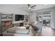 A modern living room with an entertainment center, comfy seating, and a sliding glass door to the balcony at 414 Concord St, Alpharetta, GA 30009