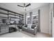 This well-lit home office is equipped with modern shelving, a comfortable couch, and multiple monitors for productivity at 414 Concord St, Alpharetta, GA 30009