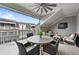 Covered patio with outdoor furniture, fan, and a view of nearby buildings providing a cozy outdoor living space at 414 Concord St, Alpharetta, GA 30009