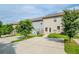 Rear view of townhouses, showcasing green lawns, patios, and trees at 235 Orchard Dr, Covington, GA 30014