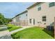 Townhome backyard featuring a lawn, fence, and a small patio area with a sliding door at 235 Orchard Dr, Covington, GA 30014