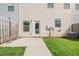 Backyard featuring grass, a concrete patio, and a door leading inside at 235 Orchard Dr, Covington, GA 30014