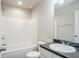 Bathroom featuring a tub with a shower, toilet, and vanity with a dark countertop at 235 Orchard Dr, Covington, GA 30014