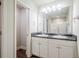 Bright bathroom boasts a double sink vanity with granite countertops at 235 Orchard Dr, Covington, GA 30014
