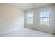 Spacious bedroom with carpeted floor and two windows providing ample natural light at 235 Orchard Dr, Covington, GA 30014